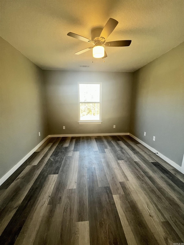 233 Iris, Benton, AR 72015 - spare room featuring a ceiling fan, baseboards, dark wood finished floors, and a textured ceiling