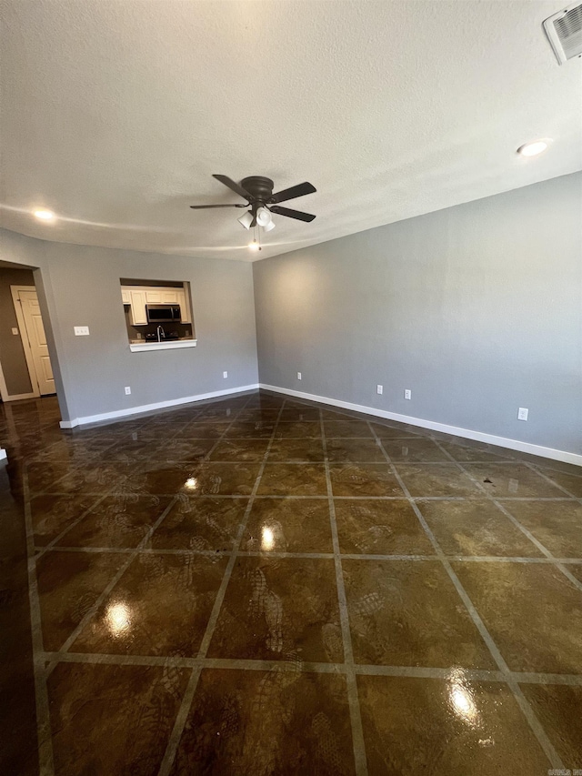 233 Iris, Benton, AR 72015 - spare room featuring ceiling fan, baseboards, and a textured ceiling