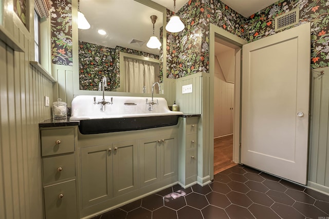 837 Maple St, Camden, AR 71701 - bathroom featuring wallpapered walls, a wainscoted wall, a sink, and tile patterned flooring