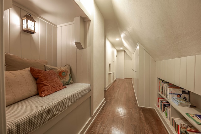 837 Maple St, Camden, AR 71701 - corridor with hardwood / wood-style flooring, lofted ceiling, a textured ceiling, and a decorative wall