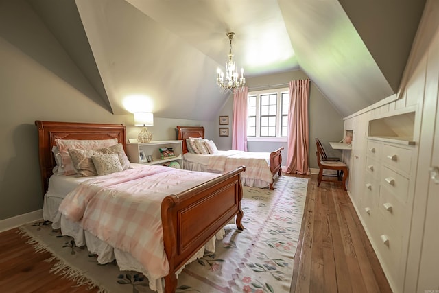837 Maple St, Camden, AR 71701 - bedroom featuring light wood-type flooring, vaulted ceiling, a chandelier, and baseboards