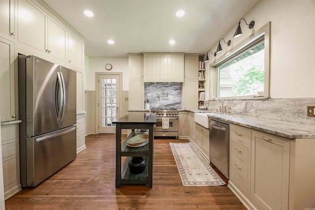 837 Maple St, Camden, AR 71701 - kitchen with appliances with stainless steel finishes, tasteful backsplash, dark wood-style floors, recessed lighting, and light stone countertops