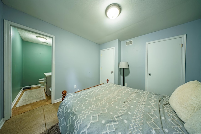 1417 Meadowbrook Dr, Heber Springs, AR 72543 - bedroom featuring tile patterned floors, connected bathroom, and baseboards