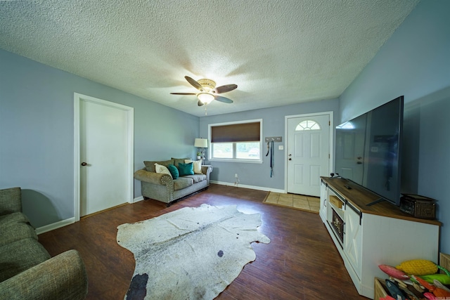 1417 Meadowbrook Dr, Heber Springs, AR 72543 - living area with dark wood-type flooring, ceiling fan, a textured ceiling, and baseboards