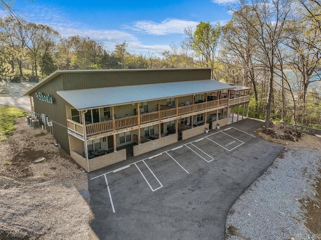 1912A5 Central Blvd, Bull Shoals, AR 72619 - view of property featuring uncovered parking, central AC unit, and view of wooded area