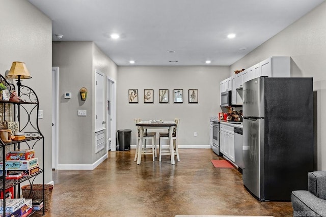 1912A5 Central Blvd, Bull Shoals, AR 72619 - kitchen featuring stainless steel appliances, concrete flooring, white cabinets, baseboards, and recessed lighting