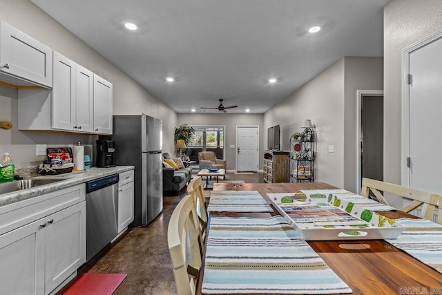 1912A5 Central Blvd, Bull Shoals, AR 72619 - kitchen featuring stainless steel dishwasher, a ceiling fan, finished concrete floors, recessed lighting, and white cabinetry