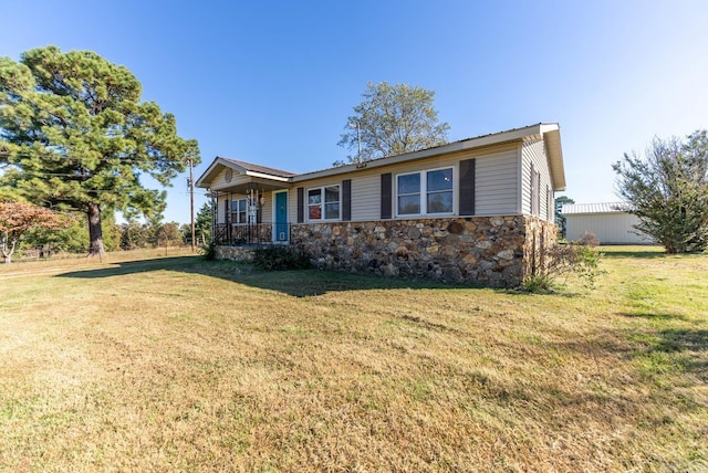 single story home with a porch, a front lawn, and stone siding