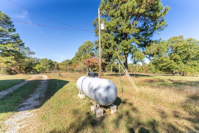 view of grassy yard with a wooded view