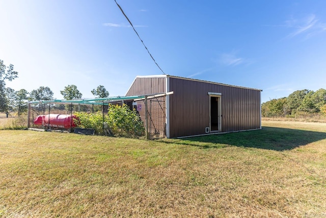 view of pole building with a yard and oil tank