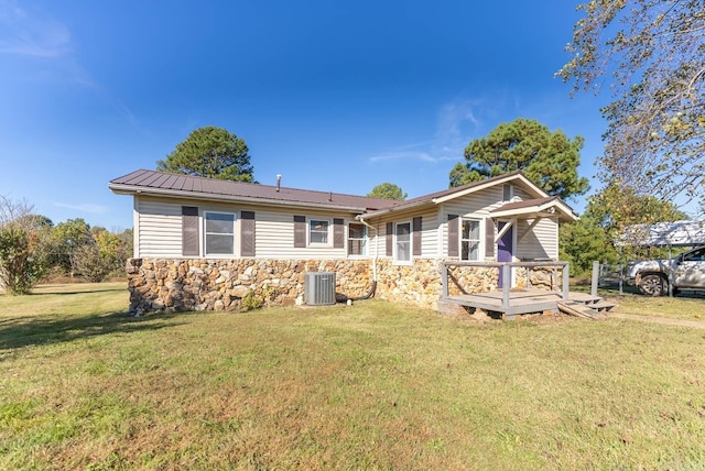 view of front of house featuring stone siding, a front yard, a wooden deck, and central AC unit
