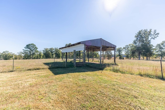 view of green lawn with a detached carport