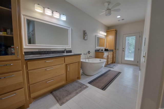 343 Boulder Rd, Royal, AR 71968 - bathroom with two vanities, ceiling fan, and a soaking tub