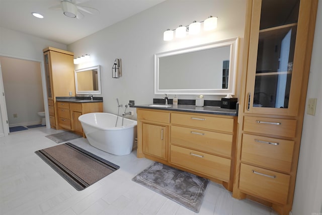 343 Boulder Rd, Royal, AR 71968 - bathroom with two vanities, a freestanding tub, and a ceiling fan
