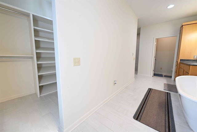 343 Boulder Rd, Royal, AR 71968 - full bathroom featuring a soaking tub, a walk in closet, vanity, tile patterned floors, and recessed lighting