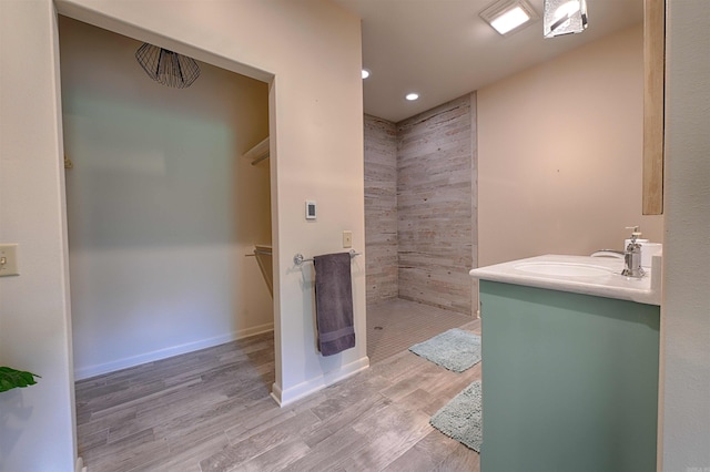 343 Boulder Rd, Royal, AR 71968 - full bathroom with tiled shower, wood finished floors, vanity, recessed lighting, and a spacious closet