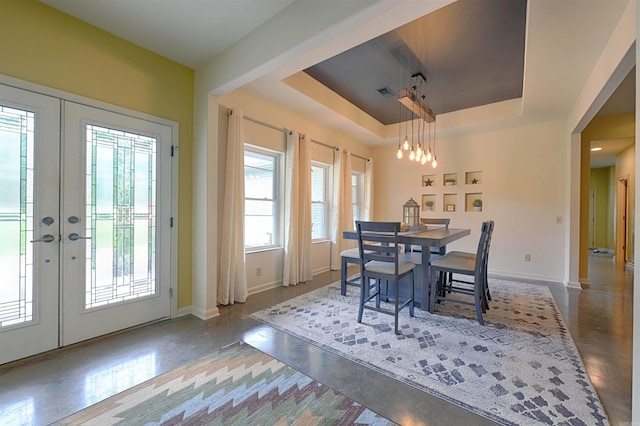 343 Boulder Rd, Royal, AR 71968 - dining room with french doors, a tray ceiling, a chandelier, and concrete floors