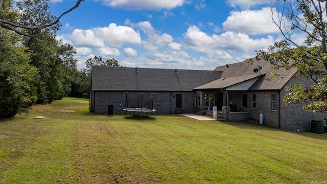 3 E Castlepines, Greenbrier, AR 72058 - back of property with a patio, a trampoline, a yard, and central AC
