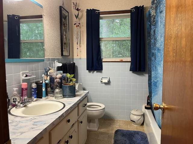 1702 E Spring Dr, Horseshoe Bend, AR 72512 - full bathroom featuring vanity, tile walls, tile patterned flooring, toilet, and plenty of natural light