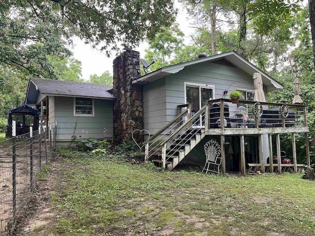 1702 E Spring Dr, Horseshoe Bend, AR 72512 - back of house with a wooden deck, a chimney, and stairs