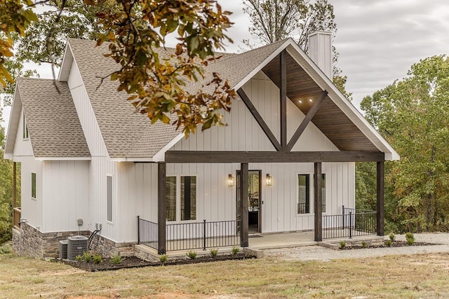 38 Oak Ridge Dr, Gepp, AR 72538 - rear view of property with a shingled roof, a porch, a chimney, a lawn, and central AC unit