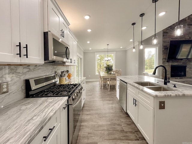 38 Oak Ridge Dr, Gepp, AR 72538 - kitchen with appliances with stainless steel finishes, a sink, wood finished floors, recessed lighting, and ornamental molding