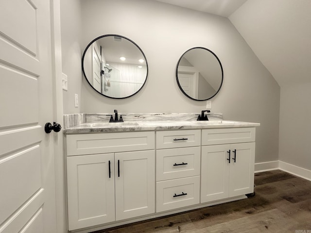 38 Oak Ridge Dr, Gepp, AR 72538 - full bath featuring double vanity, wood finished floors, lofted ceiling, and baseboards