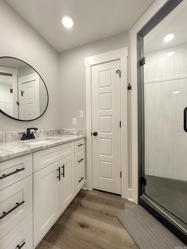 38 Oak Ridge Dr, Gepp, AR 72538 - full bathroom featuring vanity, wood finished floors, a stall shower, and recessed lighting