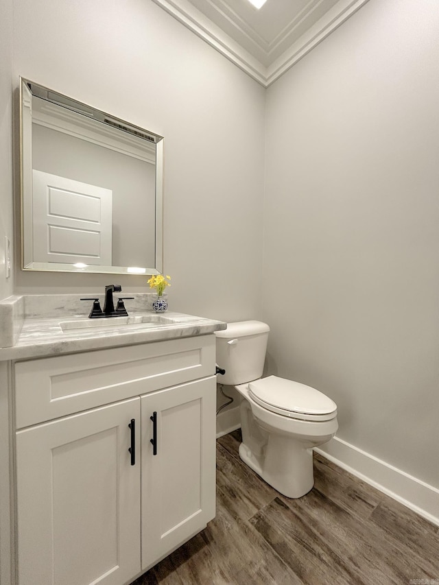 38 Oak Ridge Dr, Gepp, AR 72538 - half bathroom with wood finished floors, vanity, baseboards, toilet, and ornamental molding