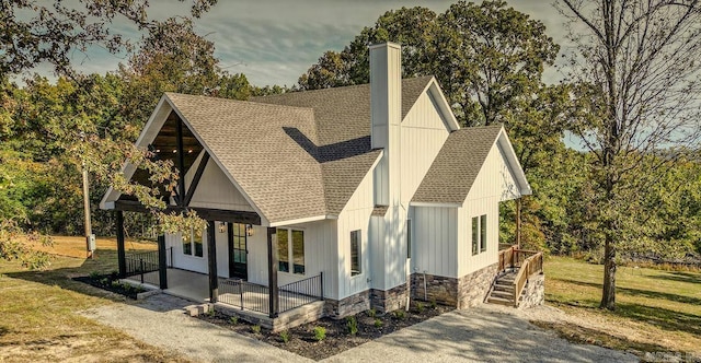 38 Oak Ridge Dr, Gepp, AR 72538 - modern inspired farmhouse with a porch, roof with shingles, a chimney, and a front lawn