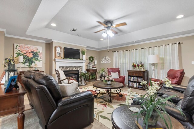 111 Country Oaks Dr, Malvern, AR 72104 - living room featuring a raised ceiling, a ceiling fan, a stone fireplace, recessed lighting, and ornamental molding