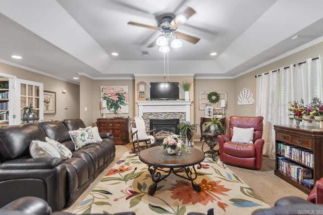 111 Country Oaks Dr, Malvern, AR 72104 - living room with a raised ceiling, a ceiling fan, a stone fireplace, carpet floors, and ornamental molding