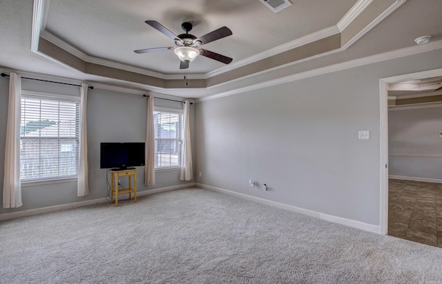 68 Smarty Jones Cir, Austin, AR 72007 - unfurnished living room featuring a tray ceiling, crown molding, ceiling fan, carpet, and baseboards
