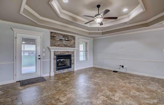 68 Smarty Jones Cir, Austin, AR 72007 - unfurnished living room with a raised ceiling, a ceiling fan, a fireplace, crown molding, and stone finish floors