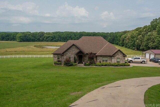 402 Nicholson Rd, Searcy, AR 72143 - view of front facade with stone siding, a detached garage, and a view of trees