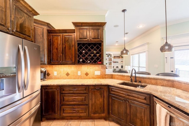 402 Nicholson Rd, Searcy, AR 72143 - kitchen featuring appliances with stainless steel finishes, a sink, light stone countertops, ornamental molding, and hanging light fixtures