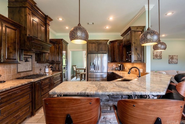 402 Nicholson Rd, Searcy, AR 72143 - kitchen featuring a sink, stainless steel appliances, light stone counters, tasteful backsplash, and dark brown cabinets