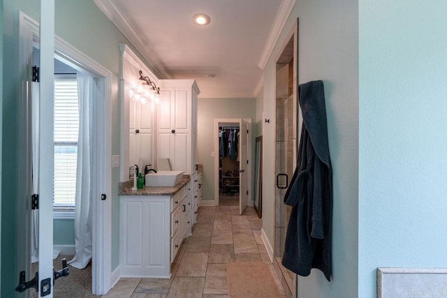 402 Nicholson Rd, Searcy, AR 72143 - bathroom featuring vanity, a spacious closet, ornamental molding, baseboards, and healthy amount of natural light