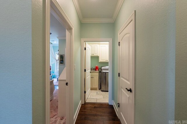 402 Nicholson Rd, Searcy, AR 72143 - corridor featuring crown molding, dark wood-style flooring, and washer / dryer