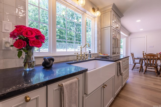 40 Tennyson Ct, North Little Rock, AR 72116 - kitchen with a sink, healthy amount of natural light, light wood-type flooring, dark stone counters, and recessed lighting