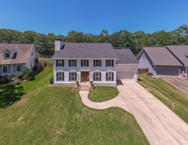 40 Tennyson Ct, North Little Rock, AR 72116 - colonial-style house featuring driveway, a chimney, and a garage