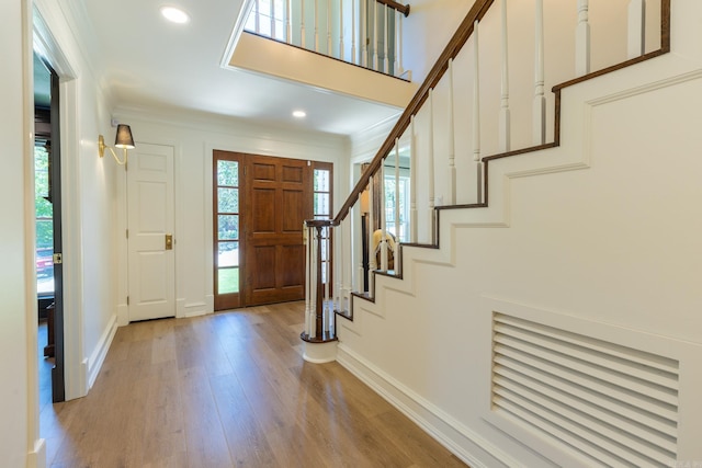 40 Tennyson Ct, North Little Rock, AR 72116 - entrance foyer featuring baseboards, light wood-style floors, crown molding, stairs, and recessed lighting