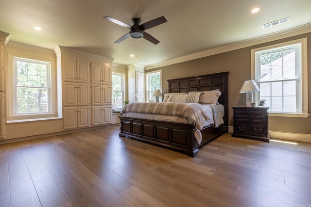 40 Tennyson Ct, North Little Rock, AR 72116 - bedroom featuring multiple windows, light wood-type flooring, ornamental molding, and recessed lighting