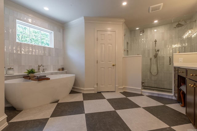 40 Tennyson Ct, North Little Rock, AR 72116 - full bathroom featuring vanity, a tile shower, a freestanding tub, recessed lighting, and baseboards