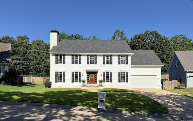 40 Tennyson Ct, North Little Rock, AR 72116 - colonial house featuring concrete driveway, a chimney, and a garage