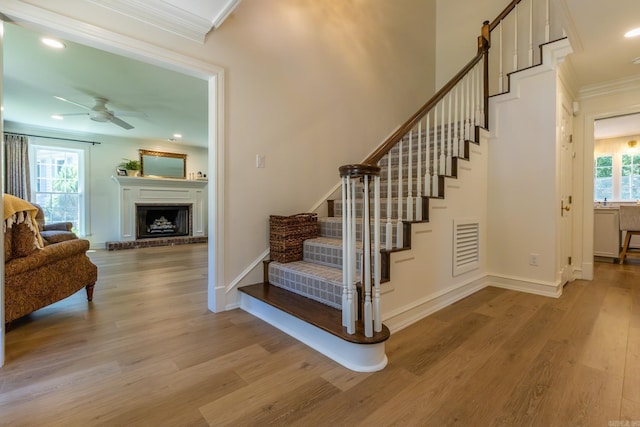 40 Tennyson Ct, North Little Rock, AR 72116 - stairway with ornamental molding, wood finished floors, ceiling fan, baseboards, and a fireplace