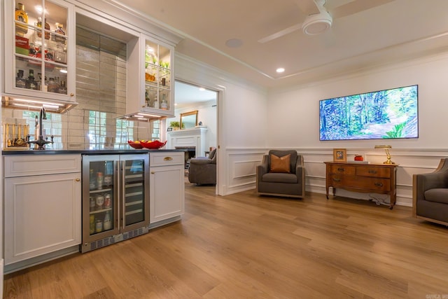 40 Tennyson Ct, North Little Rock, AR 72116 - indoor wet bar featuring wine cooler, light wood-style flooring, crown molding, a ceiling fan, and recessed lighting