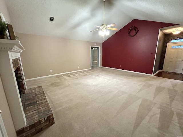 1828 Dove Dr, Benton, AR 72015 - unfurnished living room with light colored carpet, a ceiling fan, lofted ceiling, a fireplace, and a textured ceiling