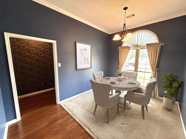 1828 Dove Dr, Benton, AR 72015 - dining space with a chandelier, ornamental molding, wood finished floors, a textured ceiling, and baseboards
