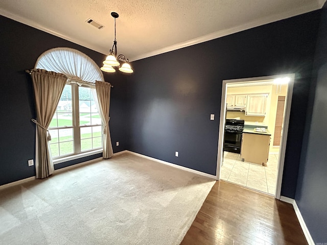 1828 Dove Dr, Benton, AR 72015 - spare room featuring a chandelier, a textured ceiling, ornamental molding, baseboards, and light wood-style floors